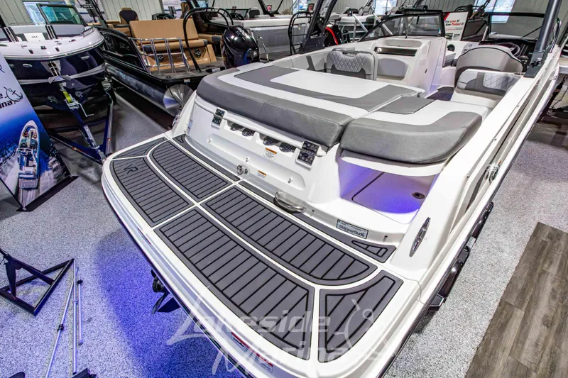 Slide: The Image of 2023 Bayliner VR6 Bowrider I/O boat with spacious seating and modern design in showroom. - 9