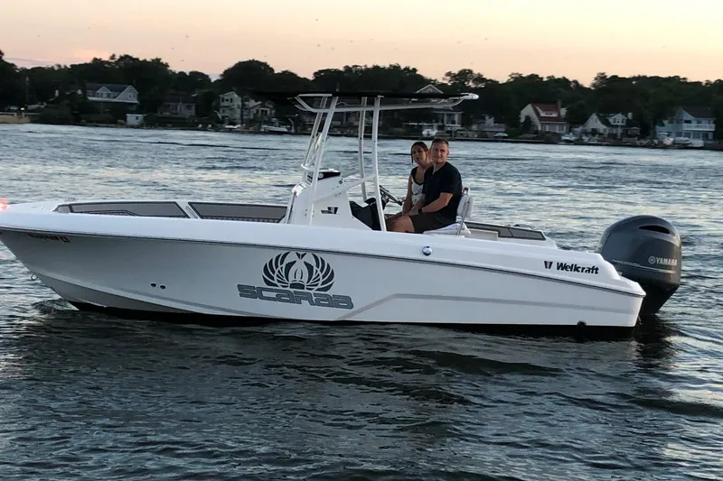 The Image of 2019 Wellcraft 202 Fisherman boat on water at sunset with two passengers. - 0