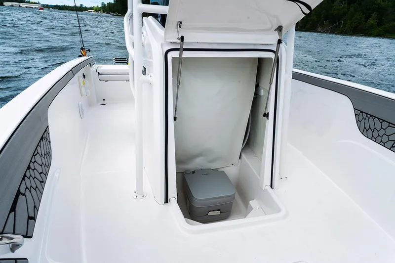 Slide: The Image of Manufacturer Provided Image: 2019 Wellcraft 202 Fisherman boat interior with open storage compartment. - 10