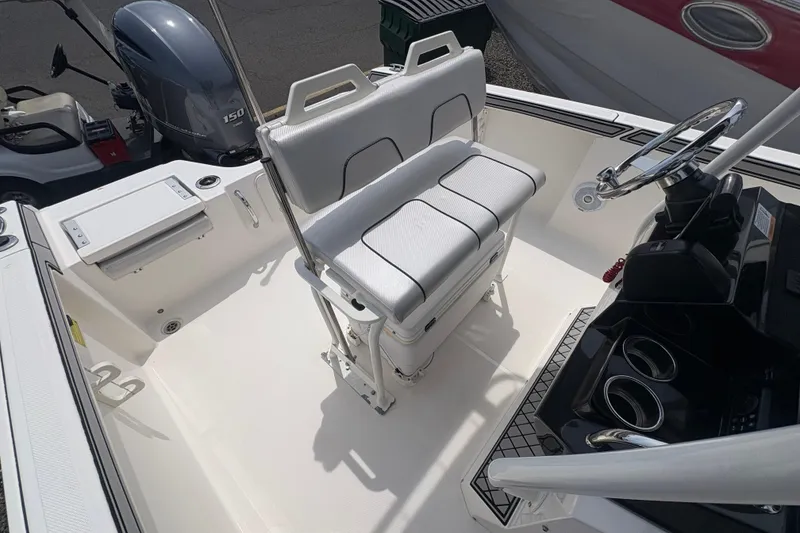 Slide: The Image of Interior of a 2019 Wellcraft 202 Fisherman boat with bench seating and helm console. - 12