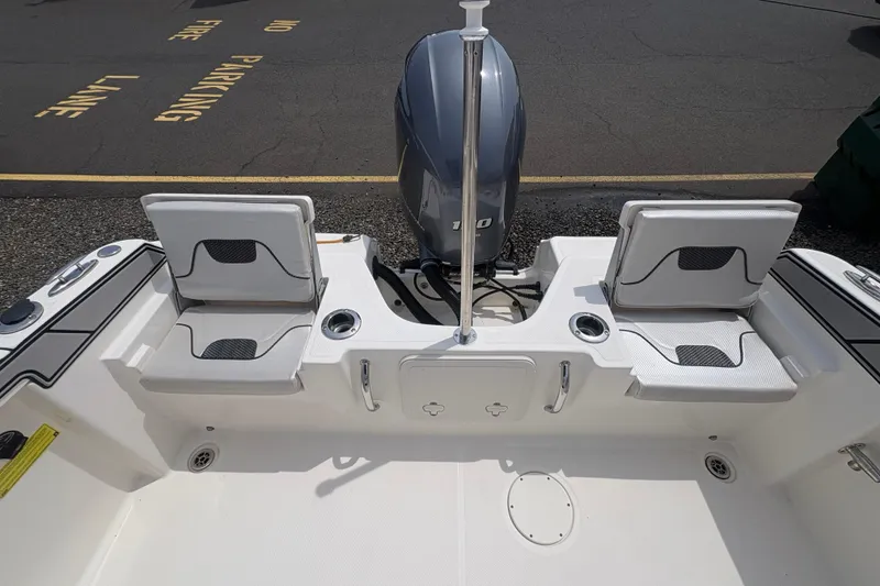 Slide: The Image of 2019 Wellcraft 202 Fisherman boat rear with motor and seating. - 14