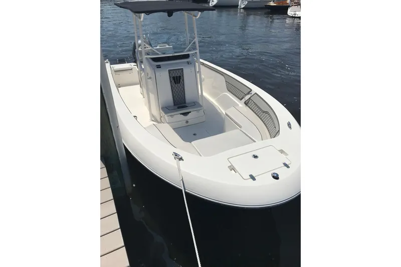 Slide: The Image of 2019 Wellcraft 202 Fisherman boat docked on calm water. - 16