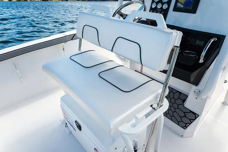 Slide: The Image of Manufacturer Provided Image: 2019 Wellcraft 202 Fisherman boat interior with white cushioned seating and console. - 7