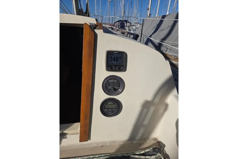 Slide: The Image of 1982 O'Day 28 sailboat cockpit with navigation instruments and wooden trim. - 11
