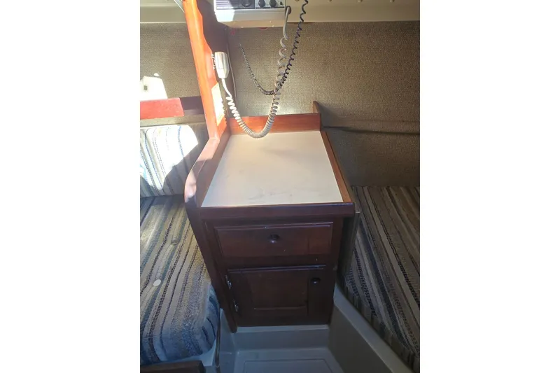 Slide: The Image of Interior of 1982 O'Day 28 sailboat with wooden cabinetry and striped seating. - 16
