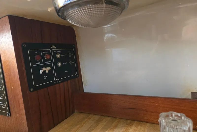 Slide: The Image of 1982 O'Day 28 sailboat interior control panel with wood finish and light fixture. - 18