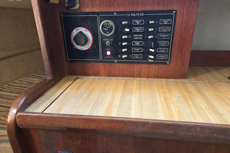 Slide: The Image of 1982 O'Day 28 sailboat electrical panel with switches and battery test gauge. - 19