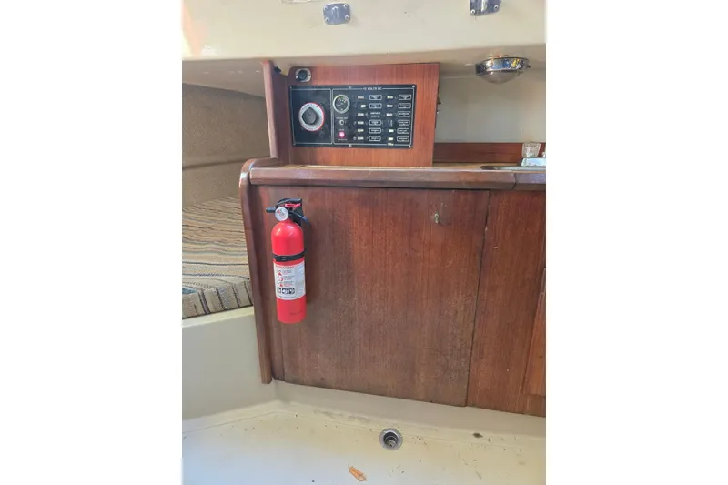Slide: The Image of 1982 O'Day 28 sailboat interior with control panel and fire extinguisher. - 20