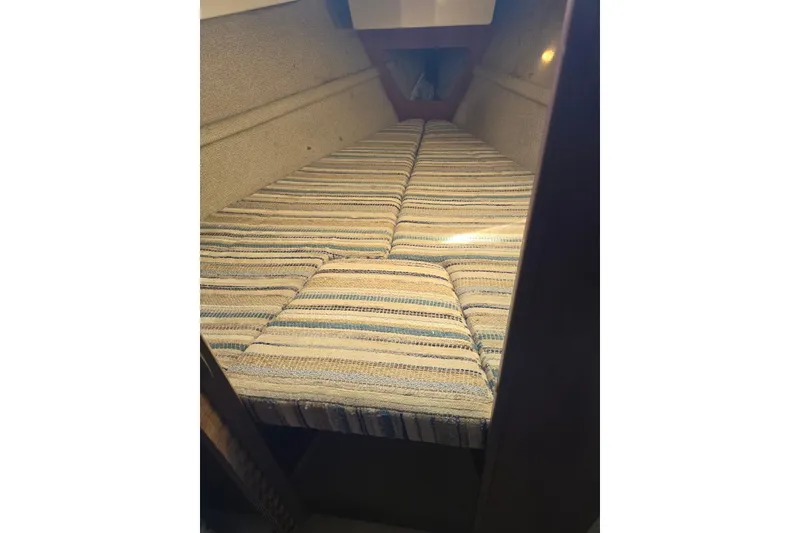 Slide: The Image of Interior cabin view of 1982 O'Day 28 sailboat with striped cushions. - 26