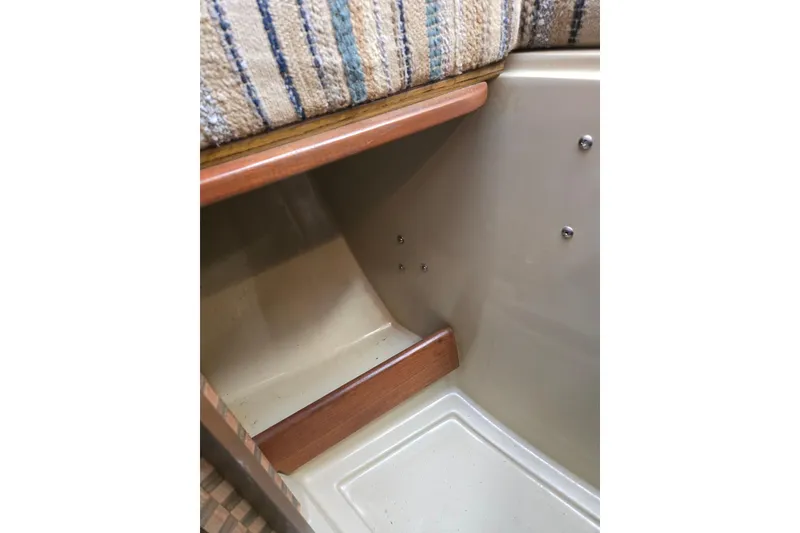 Slide: The Image of Interior detail of 1982 O'Day 28 sailboat, featuring wood trim and striped upholstery. - 29