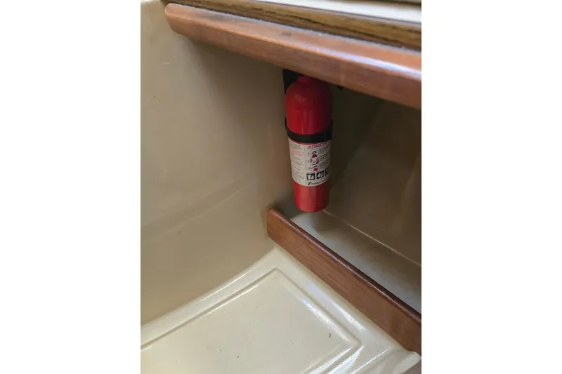 Slide: The Image of Red fire extinguisher mounted inside 1982 O'Day 28 sailboat cabin. - 30