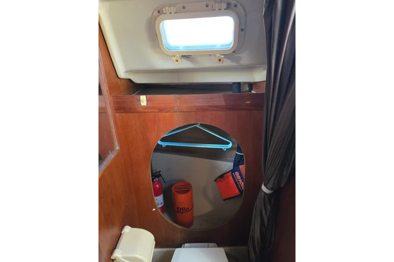 Slide: The Image of 1982 O'Day 28 sailboat interior with porthole, fire extinguisher, and life jacket. - 31
