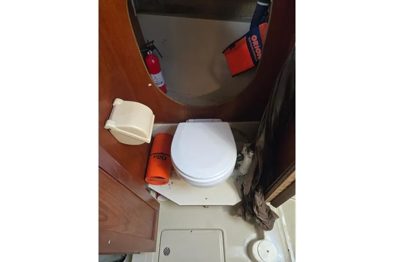 Slide: The Image of 1982 O'Day 28 sailboat bathroom with toilet, fire extinguisher, and safety equipment. - 33