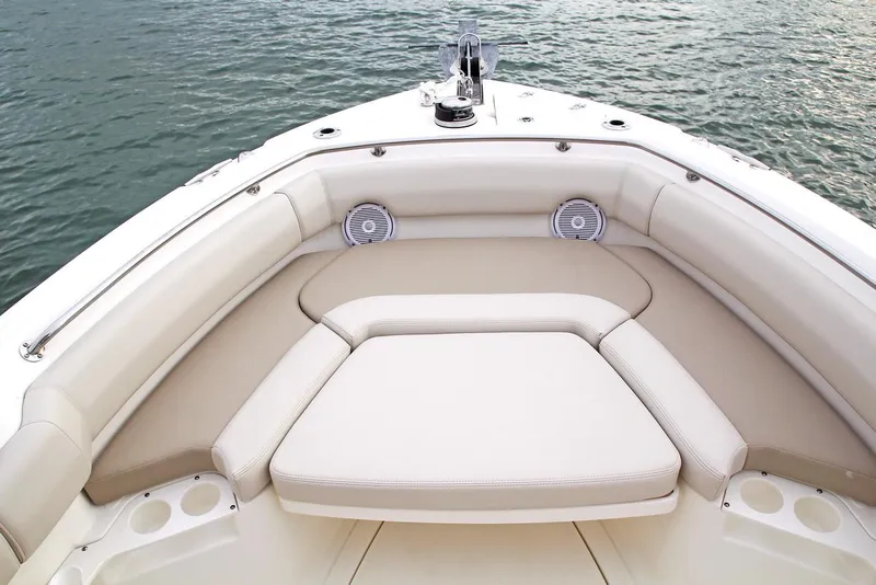 Slide: The Image of Manufacturer Provided Image: 2025 Boston Whaler 230 Outrage boat interior with cushioned seating and cup holders. - 6
