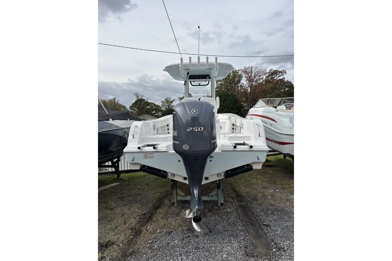 Slide: The Image of 2024 Sportsman Heritage 231 Center Console boat with Yamaha 250 engine, parked outdoors. - 1