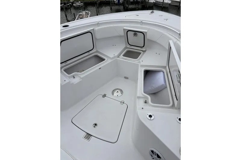 Slide: The Image of 2024 Sportsman Heritage 231 Center Console boat interior with open storage compartments. - 6