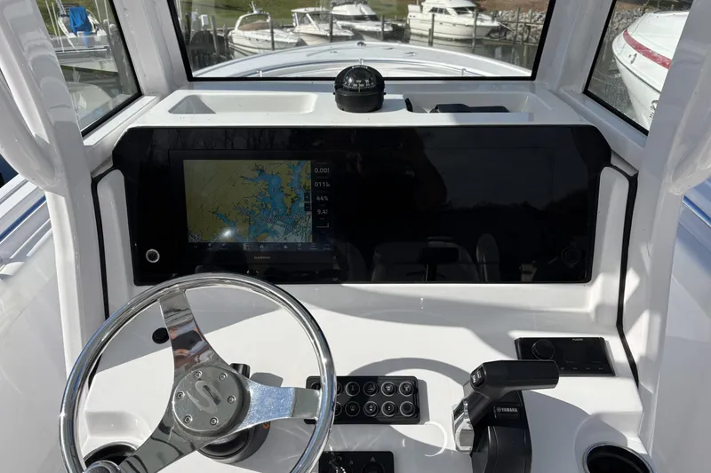 Slide: The Image of 2024 Sportsman Heritage 231 Center Console dashboard with navigation display and steering wheel. - 7