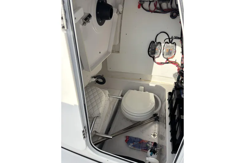 Slide: The Image of 2024 Sportsman Heritage 231 Center Console interior with toilet and wiring. - 8