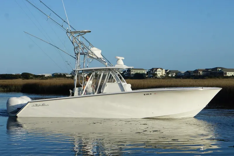 Slide: The Image of 2017 SeaHunter 35 Tournament boat on calm water, coastal homes in background. - 10