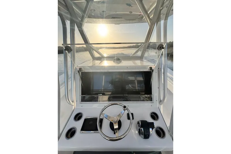 Slide: The Image of 2017 SeaHunter 35 Tournament helm with steering wheel, controls, and sunset view. - 13