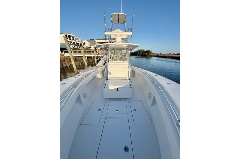 Slide: The Image of 2017 SeaHunter 35 Tournament boat on calm water, showcasing spacious deck and sleek design. - 16