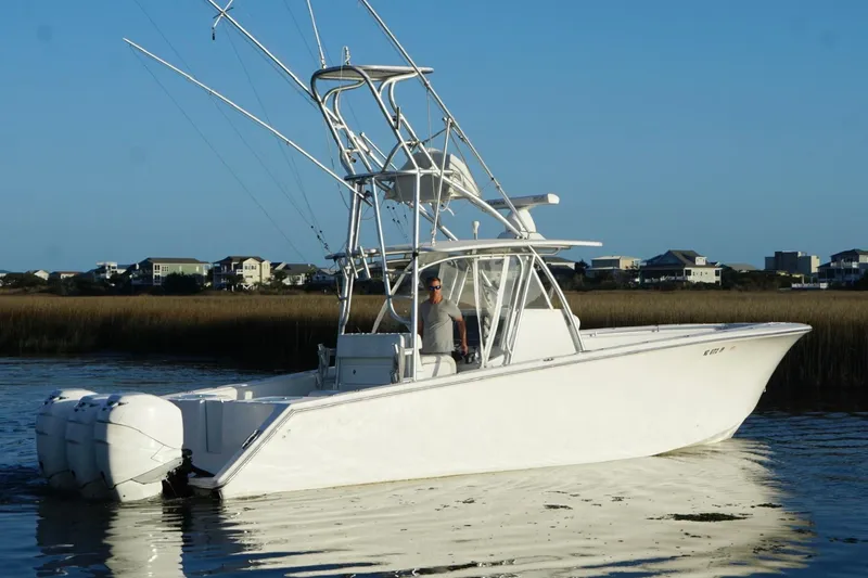 Slide: The Image of 2017 SeaHunter 35 Tournament boat on calm water with coastal homes in the background. - 3