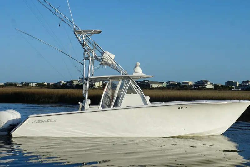 Slide: The Image of 2017 SeaHunter 35 Tournament boat on calm water, coastal houses in background. - 5