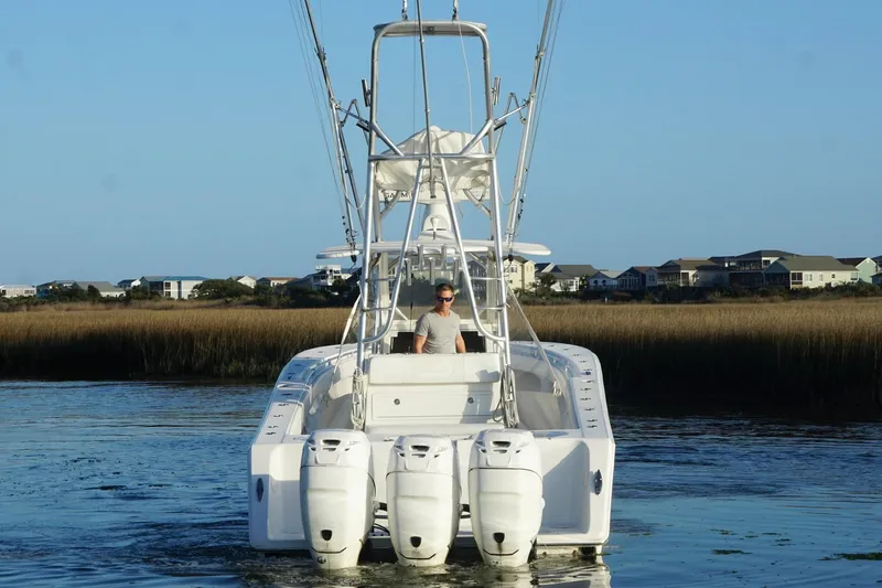Slide: The Image of 2017 SeaHunter 35 Tournament boat with triple engines on calm water. - 7