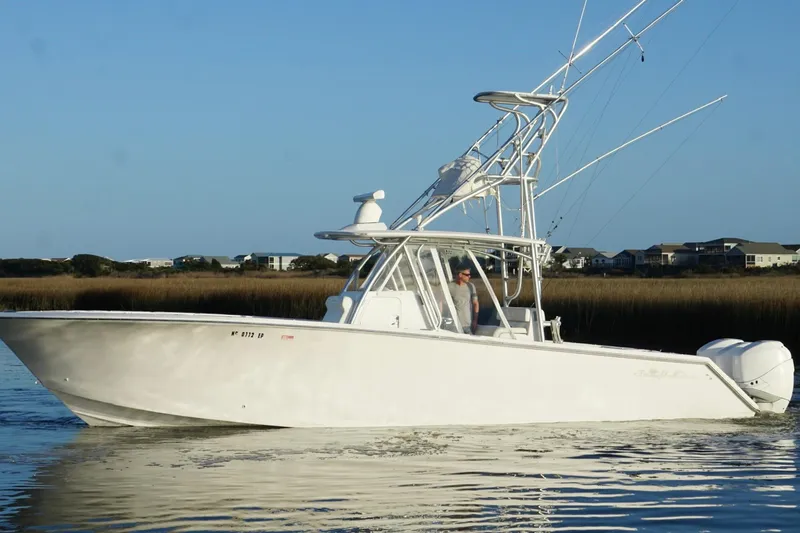 Slide: The Image of 2017 SeaHunter 35 Tournament boat cruising on calm water, clear sky background. - 8