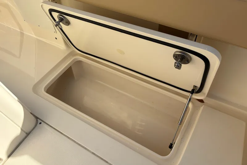 Slide: The Image of Open storage compartment on 2023 Scout 277 LXF boat. - 14