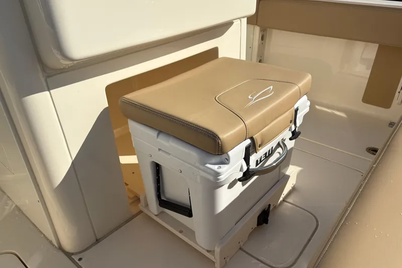 Slide: The Image of 2023 Scout 277 LXF boat interior with cushioned YETI cooler seat. - 15