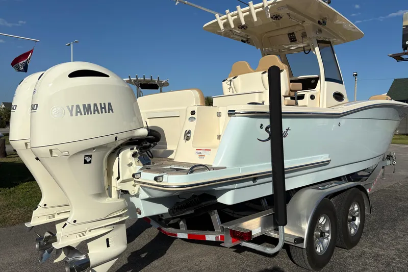 Slide: The Image of 2023 Scout 277 LXF boat with Yamaha engines on a trailer, sunny day. - 2