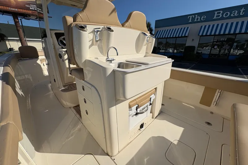 Slide: The Image of 2023 Scout 277 LXF boat interior with sink and seating area. - 21