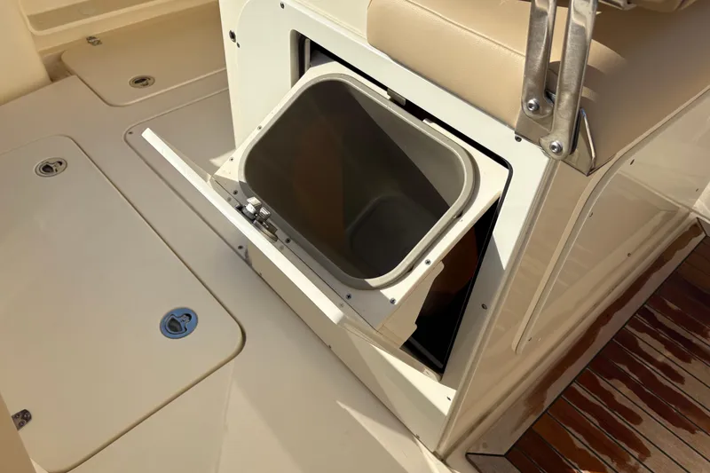 Slide: The Image of 2023 Scout 277 LXF boat interior with open storage compartment and seating. - 23