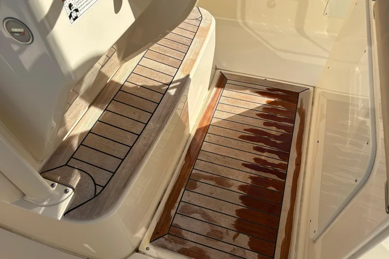 Slide: The Image of 2023 Scout 277 LXF boat interior with wooden flooring and sleek design. - 24