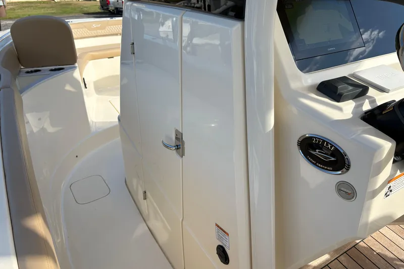 Slide: The Image of 2023 Scout 277 LXF boat interior with helm and seating area. - 29
