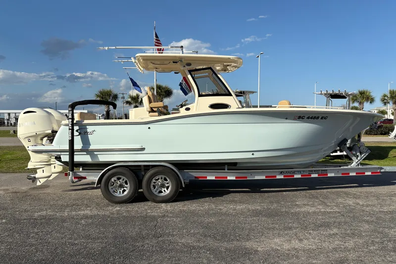 Slide: The Image of 2023 Scout 277 LXF boat on trailer, side view, clear sky background. - 3