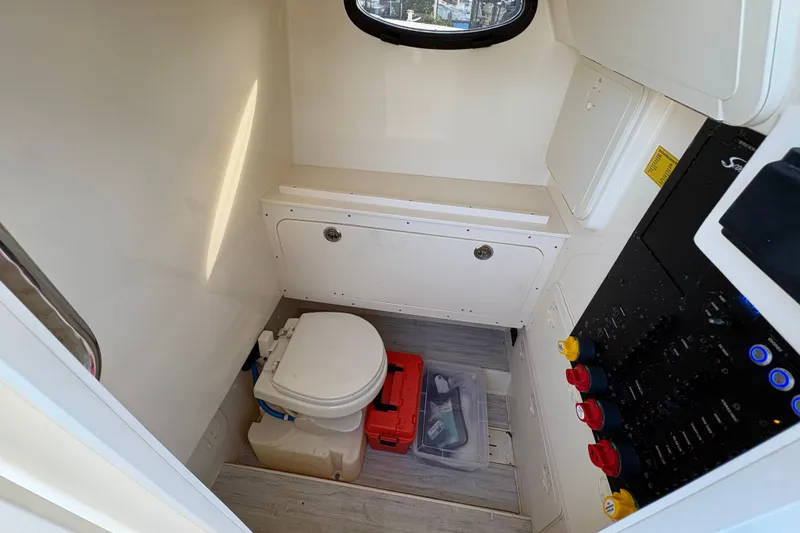 Slide: The Image of 2023 Scout 277 LXF boat interior with toilet and storage compartments. - 30