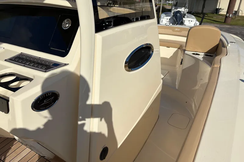 Slide: The Image of 2023 Scout 277 LXF boat interior with control panel and seating area. - 31