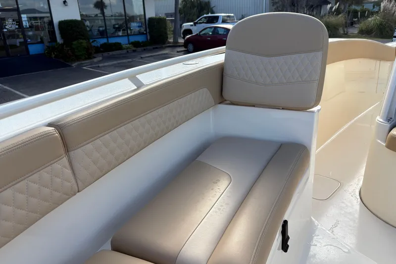 Slide: The Image of 2023 Scout 277 LXF boat interior with beige cushioned seating and diamond stitching. - 36