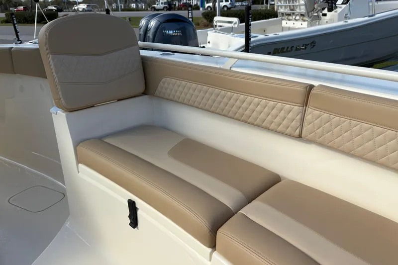 Slide: The Image of 2023 Scout 277 LXF boat with beige cushioned seating and quilted backrest. - 38
