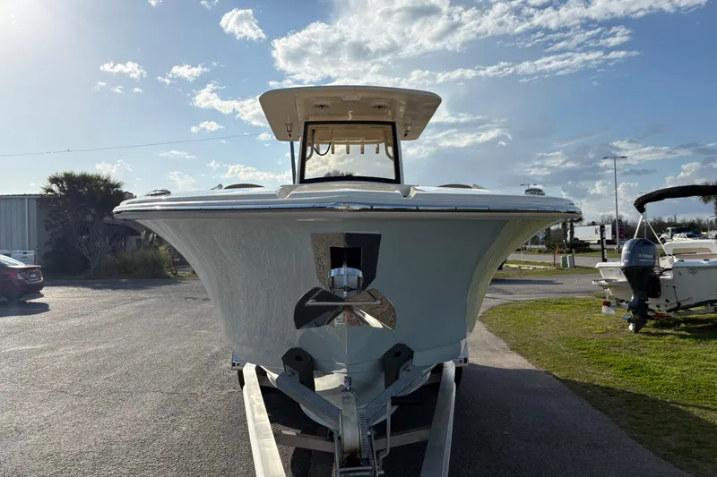 Slide: The Image of 2023 Scout 277 LXF boat on trailer under a partly cloudy sky. - 5