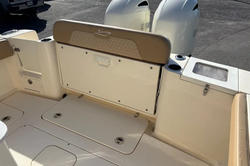 Slide: The Image of 2023 Scout 277 LXF boat interior with dual Yamaha engines and seating area. - 7