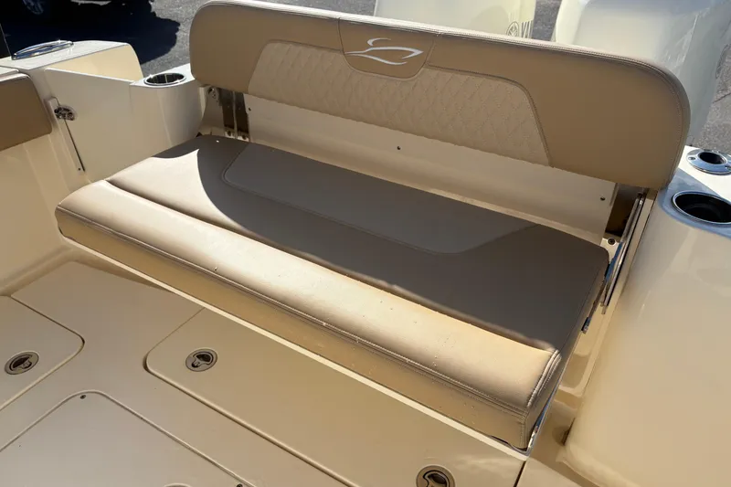 Slide: The Image of 2023 Scout 277 LXF boat seat with beige upholstery and cup holders. - 8
