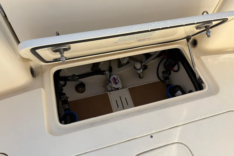 Slide: The Image of Open hatch of 2023 Scout 277 LXF boat showing internal components and wiring. - 9