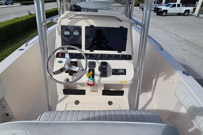 Slide: The Image of 2006 Grady-White Fisherman 222 boat interior with cushioned seating and speakers. - 14