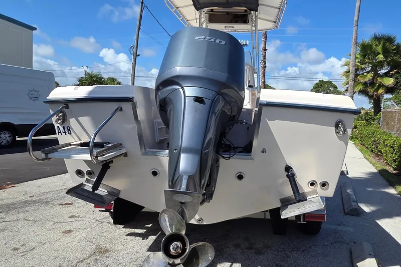 Slide: The Image of 2006 Grady-White Fisherman 222 boat with powerful outboard motor, parked outdoors. - 2