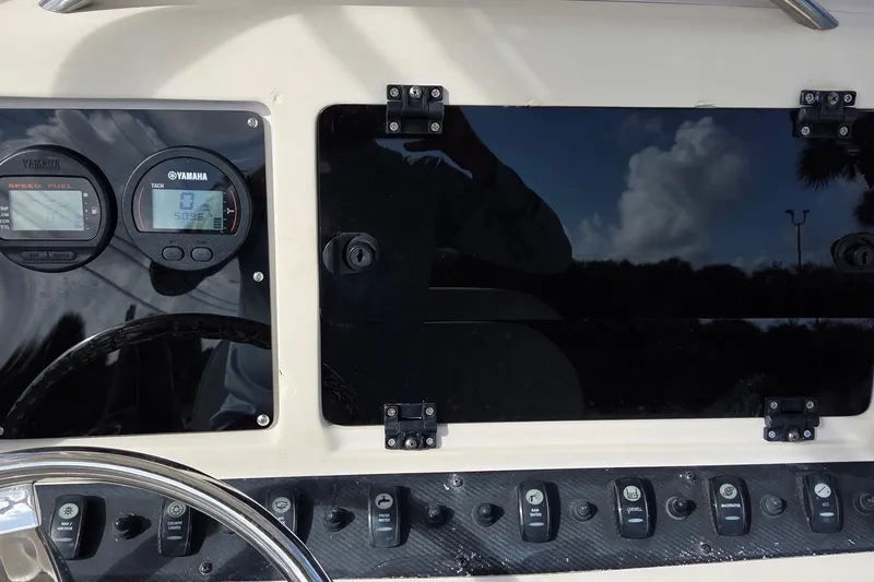 Slide: The Image of 2006 Grady-White Fisherman 222 dashboard with Yamaha gauges and control switches. - 5