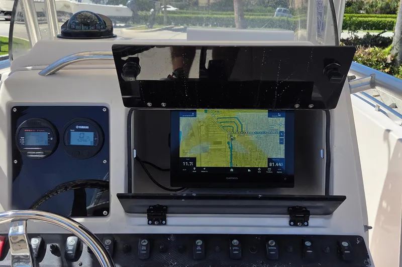 Slide: The Image of 2006 Grady-White Fisherman 222 dashboard with Garmin navigation and Yamaha gauges. - 6