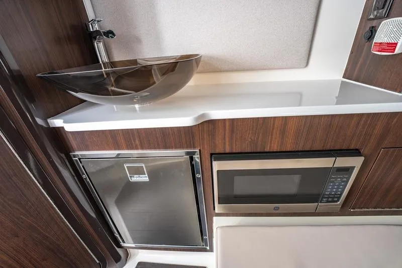 Slide: The Image of 2025 Edgewater 370CC interior with modern sink, fridge, and microwave. - 14